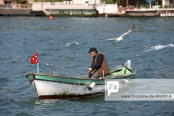 Fisherman in a boat on the Bosporus  Istanbul  Turkey