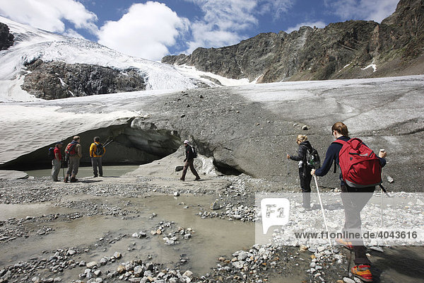 Hiking group hiking from Peiljoch alongside the Sulzen Glacier  Stubai Valley  Tyrol  Austria  Europe