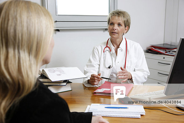 A female doctor talking to patient in a hospital doctor's office