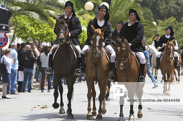 Men riding horses while wearing traditional costumes at the Cavalcata Sarda parade in Sassari  Sardinia  Italy  Europe