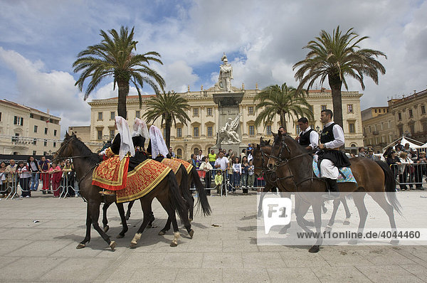Men and women riding horses while wearing traditional costumes at the Cavalcata Sarda parade on the Piazza Italia in Sassari  Sardinia  Italy  Europe