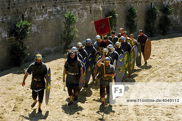 A cohort in roman legionaire uniform marching through the arena  roman games festival  Xanten Archaeological Park  Lower Rhine  North Rhine-Westphalia  Germany  Europe