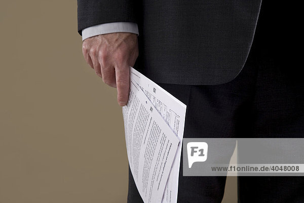 Hand of a businessman with papers
