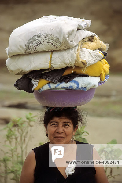 Woman carrying load on her head  Ecuador  South America