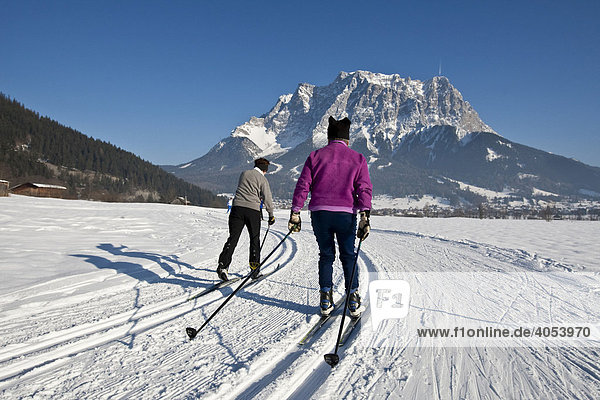 Cross-country skiers in front of Zugspitze  Zugspitz Arena  Tyrol  Austria  Europe