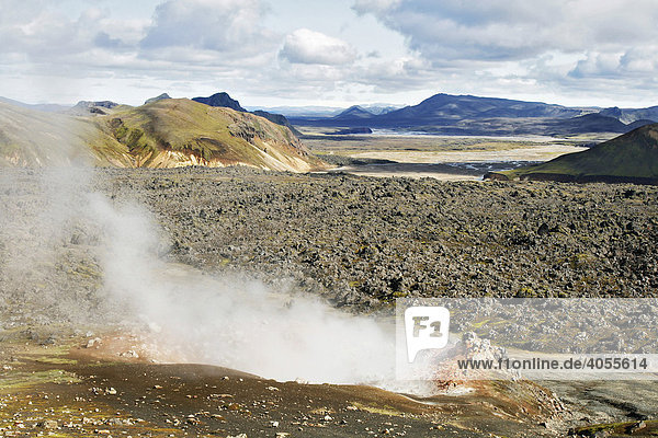 Hot and steaming springs  fumaroles  in the lava fields in front of the colourful Rhyolith Mountains of Landmannalaugar  Iceland  Europe