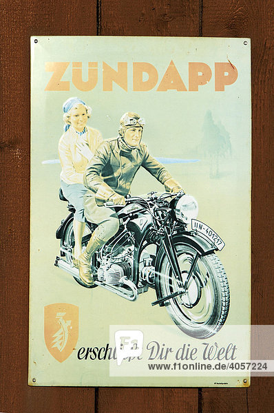 Old motorbike advertisement on a tin sign  on a wooden gate  Wichsenstein  Upper Franconia  Bavaria  Germany  Europe