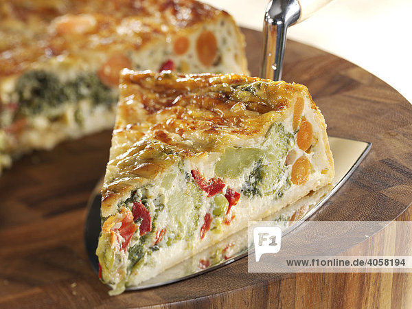 Slice of vegetable quiche on a cake server