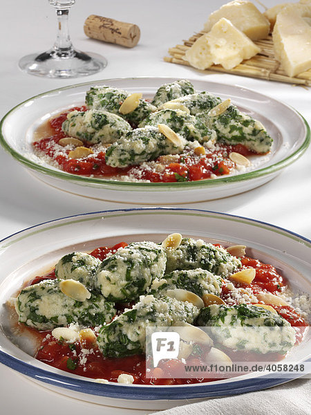 Spinach Gnocche with tomato sauce on plates