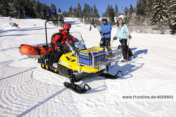 Skier and ski guard with Ski-doo in the ski area Spitzing  Bavarian Alps  Upper Bavaria  Germany  Europe