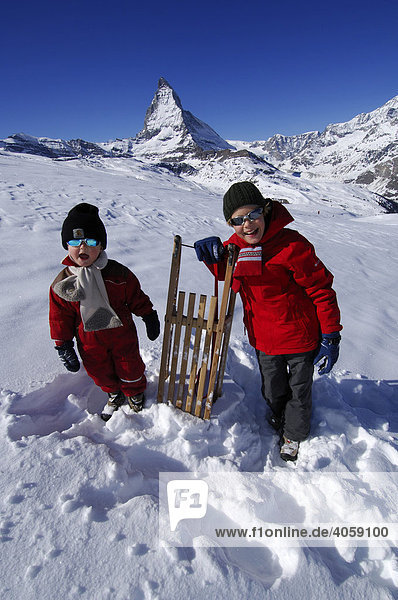 Kids with a sled  in front of the Matterhorn  Zermatt  Wallis or Valais  Switzerland  Europe