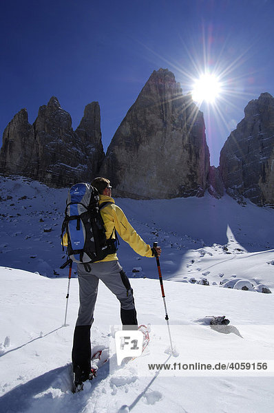 Snowshoeing in front of the mountain Drie Zinnen or Tre Cime di Lavaredo  Italian for Three Peaks of Lavaredo  Hochpustertal Valley or High Puster Valley or Alto Pusteria  Bolzano-Bozen  Dolomite Alps  Italy  Europe