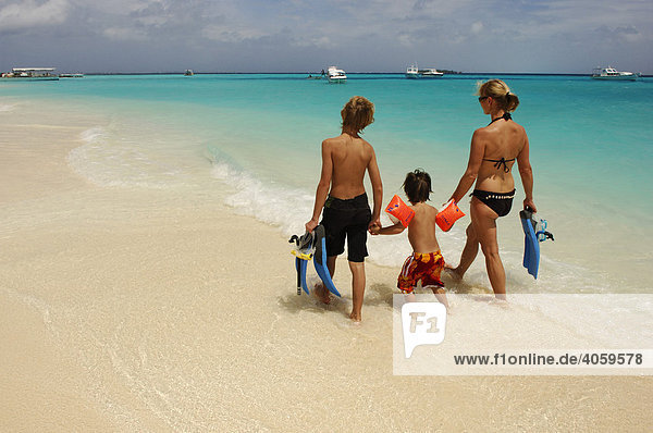 Woman and two children on the beach  Laguna Resort  The Maldives  Indian Ocean