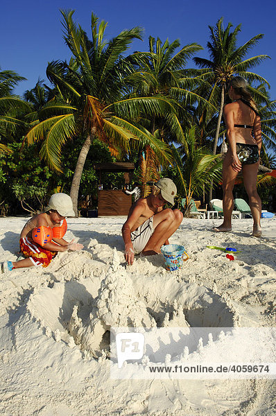 Kinder bauen am Strand eine Sandburg  Kurumba Resort  Malediven  Indischer Ozean