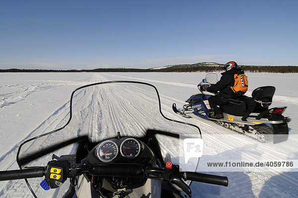 Snowmobile tour on Lake Inari  Inari  Lapland  Finland  Europe