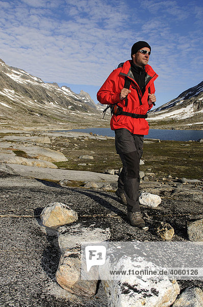 Hiker  trekking in the Ikasartivaq-Fjord  East-Greenland  Greenland