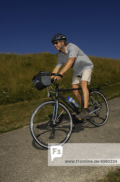Cyclist on cycle tour  Olympiazentrum  Munich  Bavaria  Germany  Europe