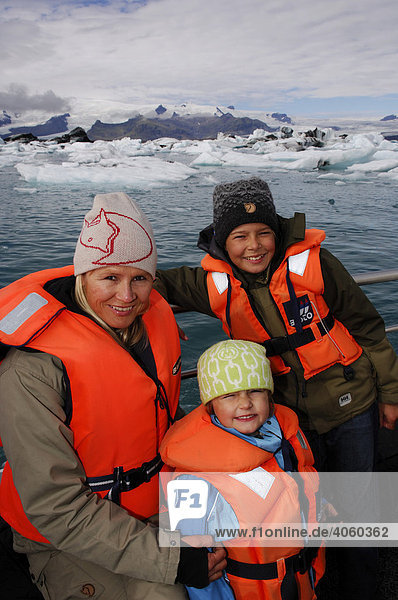 Woman and two children on a boat tour among icebergs  glacier  Joekulsarlon  Iceland  Europe