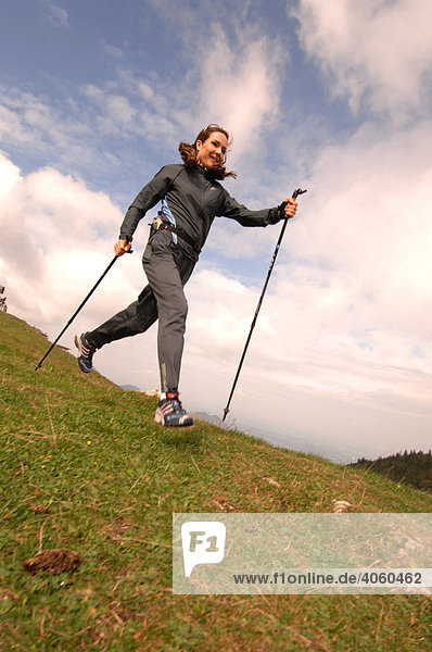 Woman running  nordic walking  Kampenwand  Chiemgau  Upper Bavaria  Bavaria  Germany  Europe