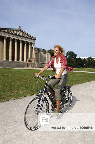Best Ager  female bicyclist  bike tour  Koenigsplatz Square  Munich  Bavaria  Germany  Europe