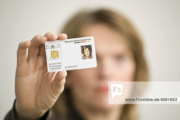 Woman holding a German electronic health insurance card