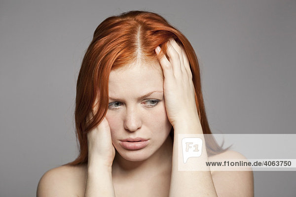 Young  red-haired woman  distressed  sad