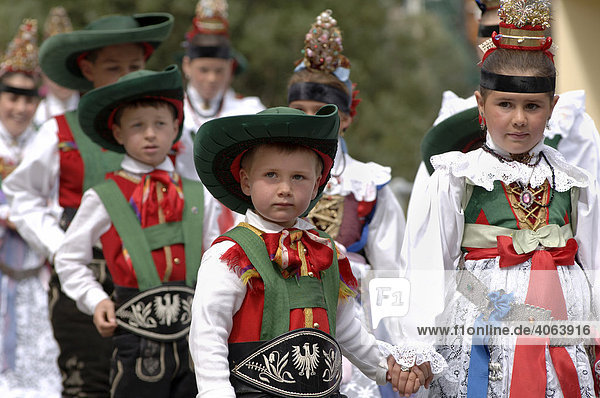 Children wearing traditional costumes of the Val Gardena Valley during a traditional procession in the village of Santa Cristina in the Val Gardena Valley  Bolzano-Bozen  Italy  Europe