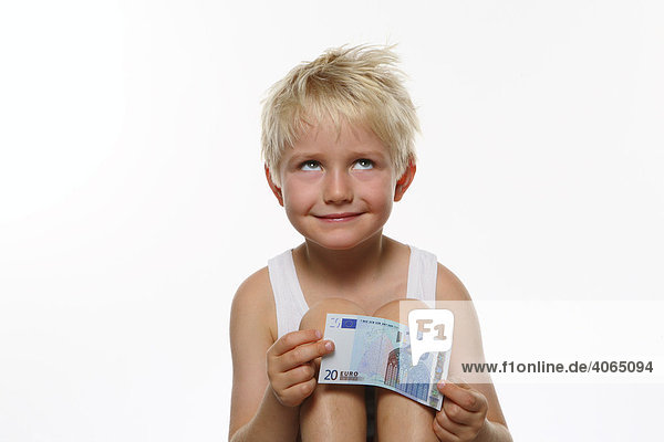 Boy holding a 20 euro bill