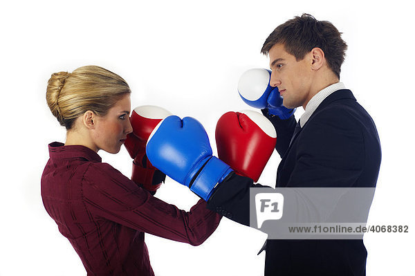 Man and woman with boxing gloves opposing each other