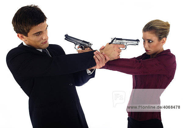 Man and woman threatening each other with pistols