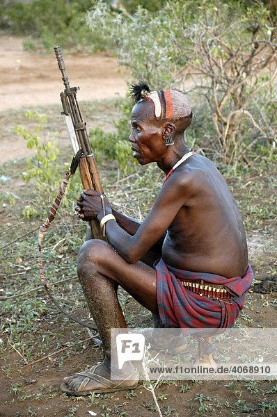 Man with rifle on the lookout  Hamar people  Turmi  Ethiopia  Africa