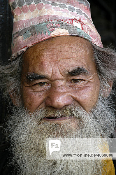Portrait  Nepalese man wearing a typical hat and a full beard  Bhaktapur  Kathmandu  Nepal  Asia