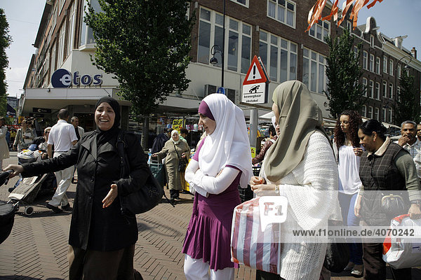 Women wearing head scarves at the Dappermarkt  a multicultural street market or bazaar in Dapperstraat  Amsterdam  Netherlands  Europe