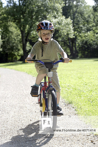 Boy riding a children's bicycle in Landshut  Bavaria  Germany  Europe