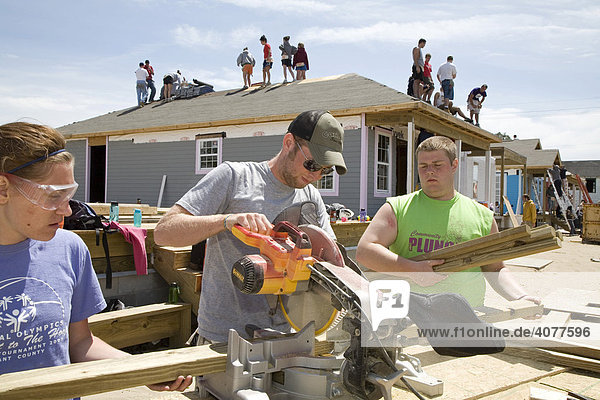 Young volunteers build new houses in a Habitat for a Humanity project to replace some of the housing destroyed by Hurricane Katrina  New Orleans  Louisiana  USA