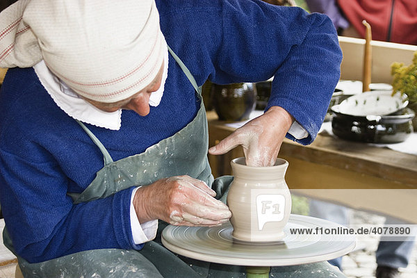 Potter making a vase on a potter's wheel