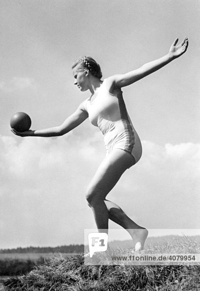 Historic photo  woman doing gymnastics with ball  ca. 1940