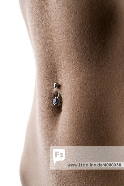 Woman's bare belly  bellybutton piercing