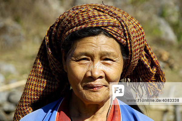 Portrait older Burmese woman in traditional dress of Pa-laung smiles Yasakyi Shan State Burma
