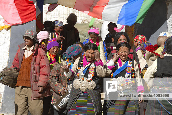 Tibetan pilgrims wear colourful traditional dress Rongbuk Monastery Tibet China