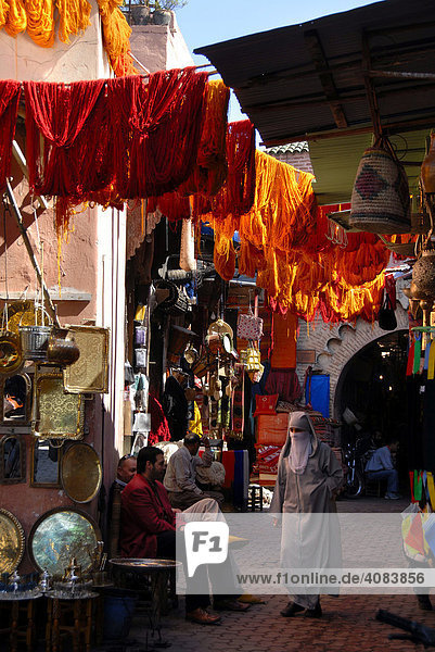 Shops and colourful cloth in the dyers quarter Souq Sebbaghine medina Marrakech Morocco