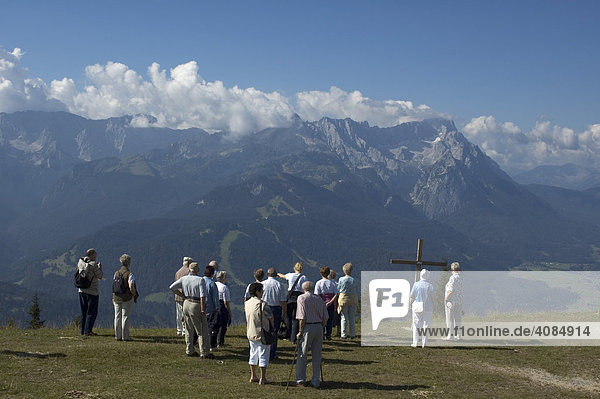 Tourist walker mountain hiker on the Wank near Garmisch-Partenkirchen view to the Zugspitze Bavaria Germany