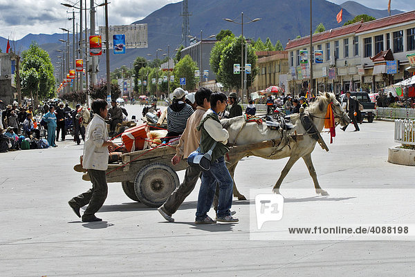 Streets scene with cart behind thin horse  Gyantse  Tibet