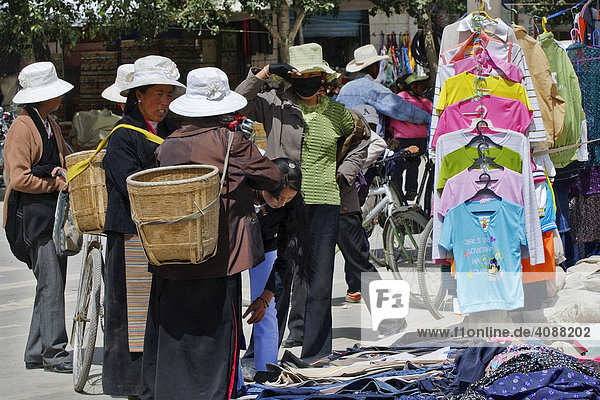 Street scene with Tibetans with clothes stands