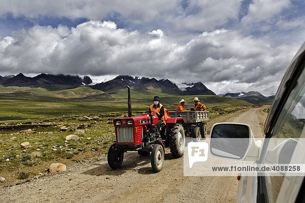 Barren mountains  motor tractors driving from Dangxiong to the Nam-Tsho-Lake  Tibet