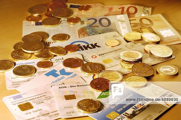 Different chip cards of German health insurance and Euro money