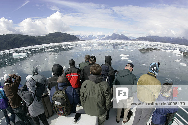 Tourist on a boat look amazed at the icebergs of the Columbia glacier Prince Williams Sound Alaska USA