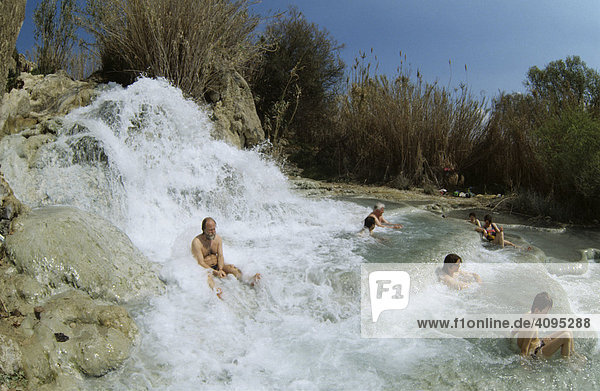 People bathing in hot spring Cascate del Molino in Saturnia Tuscany Italy