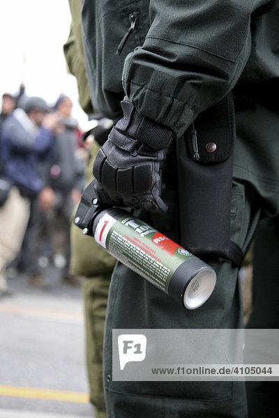 Police officer with tear gas spray in his hand