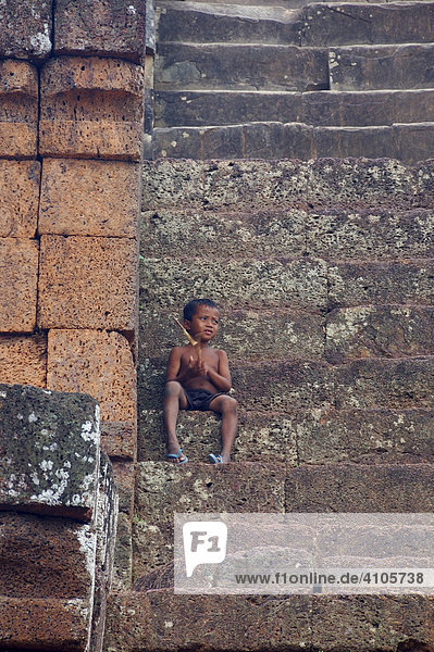 Little boy on the stairs  East Mebon temple  Angkor Wat  Cambodia